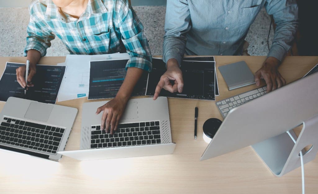 Web designers reviewing layouts while evaluating the best roofing websites for conversion patterns